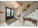 Inviting foyer with a decorative rug, statement chandelier, and elegant staircase at 1801 Maryland Ave, Charlotte, NC 28209