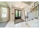 Grand foyer with black double doors, chandelier, and staircase at 1801 Maryland Ave, Charlotte, NC 28209