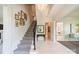 Bright foyer featuring a staircase, artwork, and views into other rooms at 1801 Maryland Ave, Charlotte, NC 28209