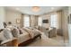 Bright main bedroom with a crystal chandelier, two seating areas and three large windows at 1801 Maryland Ave, Charlotte, NC 28209