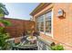 Private brick patio with lush plantings, outdoor seating, and stylish wooden fencing at 1801 Maryland Ave, Charlotte, NC 28209
