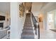 Staircase with carpet runner and dark metal railing, leading to the upper level at 1801 Maryland Ave, Charlotte, NC 28209