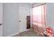 Neutral bedroom featuring light gray walls, door, artwork, pink curtains and beige carpet at 1812 Rosewell Dr, Rock Hill, SC 29732