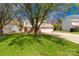 Attractive house with a well-manicured lawn and a spacious driveway, shaded by a mature tree at 1812 Rosewell Dr, Rock Hill, SC 29732