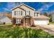 Charming two-story home with a combination of brick and siding, set against a vibrant blue sky at 1812 Rosewell Dr, Rock Hill, SC 29732