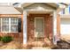 Close-up of a welcoming front porch with brick accents and a cozy 'Welcome' mat at 1812 Rosewell Dr, Rock Hill, SC 29732