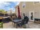 Back patio with a table and chairs, and a grill with door access to the home at 1812 Rosewell Dr, Rock Hill, SC 29732