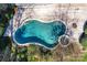Overhead shot of a sparkling backyard swimming pool, wooden deck, and lush landscaping at 18512 Square Sail Rd, Cornelius, NC 28031