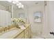 Well-lit bathroom features a double sink vanity and a shower-tub combination with tile surround at 18512 Square Sail Rd, Cornelius, NC 28031