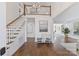 Bright foyer boasts hardwood floors, staircase, and a decorative chandelier hanging from the ceiling at 18512 Square Sail Rd, Cornelius, NC 28031