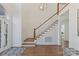 Bright foyer features hardwood floors, staircase, and a decorative glass front door at 18512 Square Sail Rd, Cornelius, NC 28031