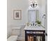 Charming powder room with decorative mirror and wall sconces at 18512 Square Sail Rd, Cornelius, NC 28031