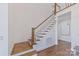 Staircase featuring wood treads, white risers and handrail at 18512 Square Sail Rd, Cornelius, NC 28031