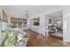 Bright open concept sunroom with hardwood floors and access to the kitchen and living room at 18512 Square Sail Rd, Cornelius, NC 28031