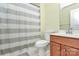 Bathroom with a sink, vanity, toilet and shower with a striped curtain at 18710 Coverdale Ct, Cornelius, NC 28031