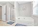 Serene bathroom featuring a separate glass enclosed shower and garden tub at 18710 Coverdale Ct, Cornelius, NC 28031