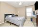 Neutral bedroom with gray bedding, bedside tables and a ceiling fan at 18710 Coverdale Ct, Cornelius, NC 28031