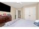 Bedroom with neutral colored walls, tv and dresser at 18710 Coverdale Ct, Cornelius, NC 28031