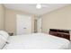 Neutral bedroom featuring a ceiling fan, large closet, and dresser at 18710 Coverdale Ct, Cornelius, NC 28031