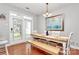 Bright dining room with a modern table set, bench seating, and access to the patio at 18710 Coverdale Ct, Cornelius, NC 28031