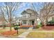 Inviting two-story home showcasing a well-manicured lawn, covered porch, and classic architectural style at 18710 Coverdale Ct, Cornelius, NC 28031