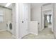 Hallway with white walls, laundry room and carpeted floor at 18710 Coverdale Ct, Cornelius, NC 28031