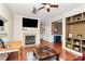 Spacious living room with a fireplace, hardwood floors, and ample natural light at 18710 Coverdale Ct, Cornelius, NC 28031