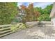 Wooden backyard deck with seating offers an outdoor retreat surrounded by mature trees at 2144 Shadyview Dr, Charlotte, NC 28210