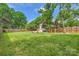 Expansive backyard with lush lawn and trees, offering plenty of space for recreation at 2144 Shadyview Dr, Charlotte, NC 28210