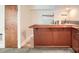 A bar area with a wooden bar top and base with a custom tiled backsplash and flooring at 2144 Shadyview Dr, Charlotte, NC 28210