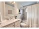 Bright bathroom showcases a marble vanity, framed mirror, and tiled shower/tub at 2144 Shadyview Dr, Charlotte, NC 28210