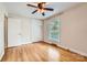 This bedroom features hardwood floors, built-in closet space, and a large, bright window at 2144 Shadyview Dr, Charlotte, NC 28210