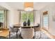 Cozy dining area with hardwood floors, elegant furniture, and serene view to the backyard at 2144 Shadyview Dr, Charlotte, NC 28210
