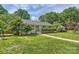 Landscaped front yard featuring a well-maintained lawn, mature trees, and welcoming entrance at 2144 Shadyview Dr, Charlotte, NC 28210
