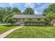 Charming home featuring a lush lawn, mature trees, and a welcoming walkway to the front entrance at 2144 Shadyview Dr, Charlotte, NC 28210
