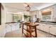 Bright kitchen featuring white cabinets, tile floor, and stainless steel appliances with a connecting dining area at 2144 Shadyview Dr, Charlotte, NC 28210
