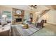 Cozy living room featuring a stone fireplace, wood mantel, and natural light from the window at 2144 Shadyview Dr, Charlotte, NC 28210