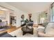 Spacious living room with stylish seating, hardwood floors, and an open layout with an adjacent dining area at 2144 Shadyview Dr, Charlotte, NC 28210
