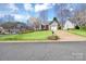 A well-manicured lawn and landscaping surround this cute home with a blossoming tree in the front yard at 2318 Kestrel Dr, Rock Hill, SC 29732