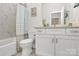 Bright bathroom featuring a white vanity, marble floors, and stylish shower curtain at 244 N Race St, Statesville, NC 28677