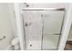 Bright bathroom featuring a glass-enclosed shower with white marbled tiling and a shower niche at 244 N Race St, Statesville, NC 28677