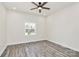 Bedroom featuring ceiling fan, gray vinyl floors, white walls, and a window at 244 N Race St, Statesville, NC 28677