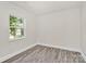 A bedroom features gray vinyl floors, white walls, and a window at 244 N Race St, Statesville, NC 28677