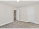 Bedroom boasting gray vinyl floors, white walls, and an open doorway at 244 N Race St, Statesville, NC 28677