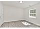 This bedroom has gray vinyl floors, white walls, and a window at 244 N Race St, Statesville, NC 28677