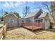 Back exterior view of the house with wood deck and large backyard at 244 N Race St, Statesville, NC 28677