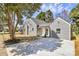 Well-maintained home with gray siding, mature trees, and a spacious driveway at 244 N Race St, Statesville, NC 28677