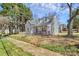 Charming two-story home with a welcoming porch, mature trees, and lush surroundings at 244 N Race St, Statesville, NC 28677