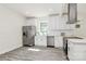 Updated kitchen with stainless appliances, white cabinets, and modern countertops at 244 N Race St, Statesville, NC 28677