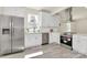 Modern kitchen with stainless steel appliances, white cabinetry, and updated backsplash at 244 N Race St, Statesville, NC 28677